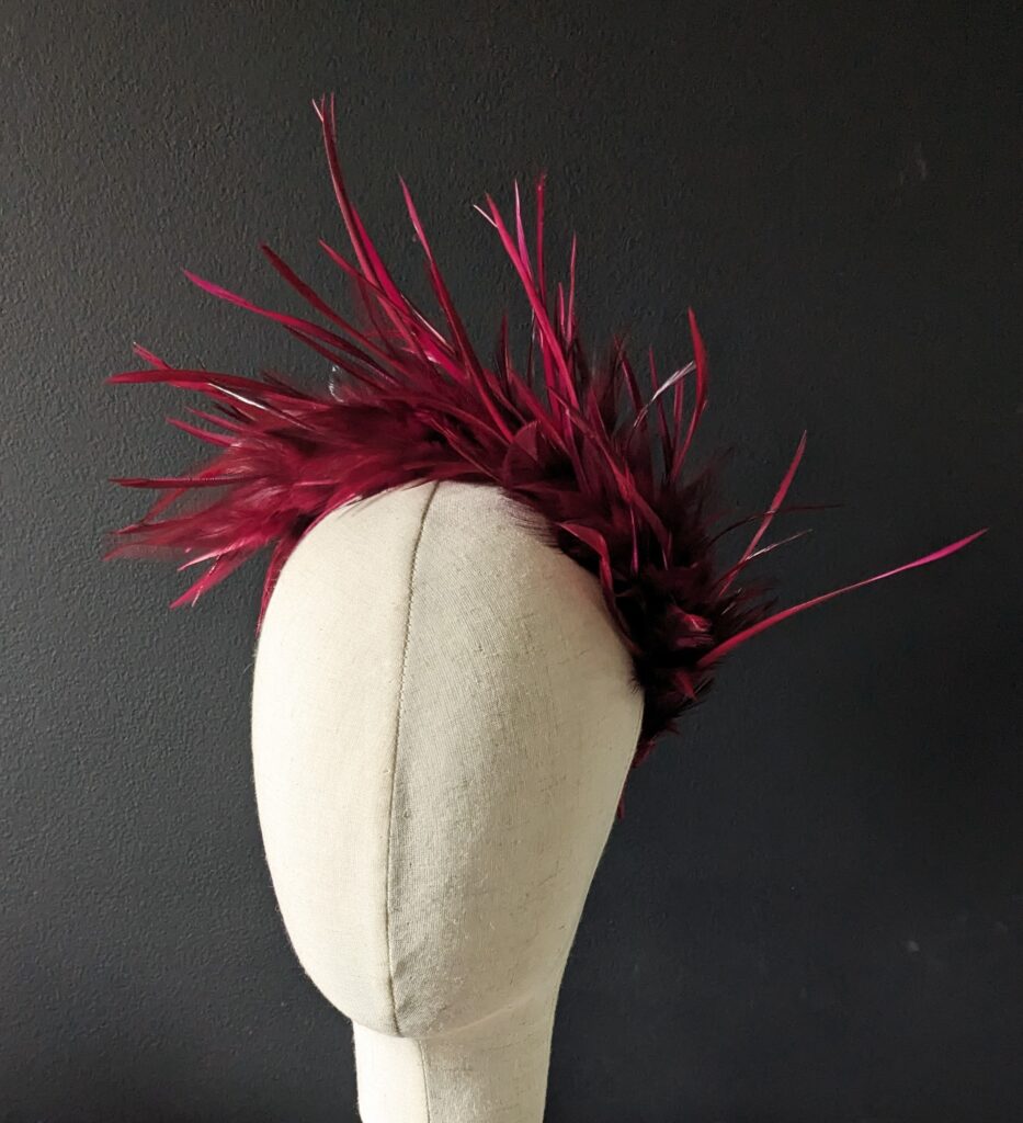 Wine spiked feather band. $35