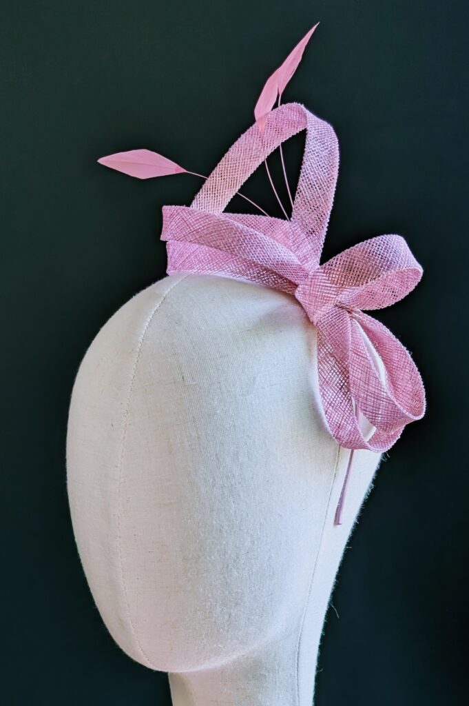 Pink sinamay fascinator on thin band. $40